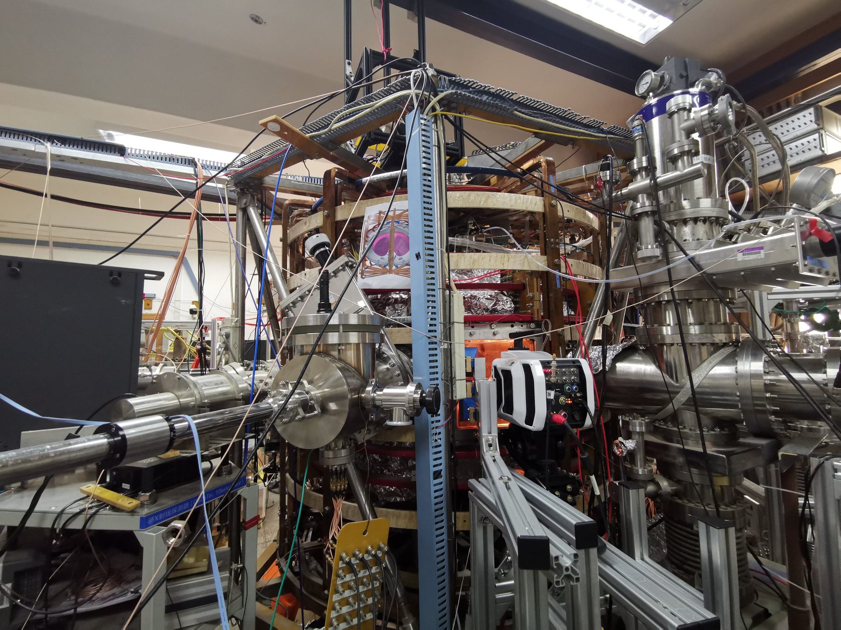 The SUNIST spherical tokamak in the laboratory, with diagnostics and cabling around the vessel